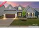 Charming home featuring a screened porch, a brown garage door, and a beautifully landscaped front yard at 471 Lucky Nw Dr, Concord, NC 28027