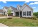 Charming home featuring a manicured lawn, a screened front porch, and a well-maintained exterior at 471 Lucky Nw Dr, Concord, NC 28027