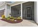 Inviting front porch featuring a screened-in area and landscaped garden with seasonal flowers at 471 Lucky Nw Dr, Concord, NC 28027