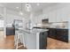 Modern kitchen featuring an island with a gray countertop, white cabinets and stainless steel appliances at 471 Lucky Nw Dr, Concord, NC 28027