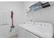 Well-lit laundry room includes a washer, dryer, and shelving at 471 Lucky Nw Dr, Concord, NC 28027