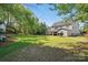 Lush backyard with expansive lawn and mature trees, providing a private and tranquil outdoor space at 4853 Walnut Grove St, Harrisburg, NC 28075
