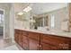 Primary bathroom features double sinks, a large mirror, and a glass enclosed shower at 4853 Walnut Grove St, Harrisburg, NC 28075
