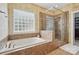 Primary bathroom with separate tub and glass shower at 4853 Walnut Grove St, Harrisburg, NC 28075