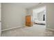 Well-lit bedroom featuring neutral walls and view into the second bedroom at 4853 Walnut Grove St, Harrisburg, NC 28075
