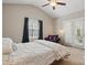 Bright bedroom featuring a ceiling fan, access to the outside, and a cozy reading chair at 4853 Walnut Grove St, Harrisburg, NC 28075