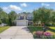 Charming two-story home featuring a well-kept lawn, a lush garden, and a concrete driveway at 4853 Walnut Grove St, Harrisburg, NC 28075