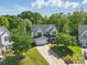 Traditional two-story home with manicured lawn and a driveway, surrounded by mature trees at 4853 Walnut Grove St, Harrisburg, NC 28075