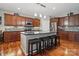 Modern kitchen with a large island, dark cabinets, stainless steel appliances, and an eye-catching backsplash at 4853 Walnut Grove St, Harrisburg, NC 28075
