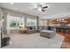 Open-concept living room features large windows, a comfortable sofa, and seamless access to the kitchen at 4853 Walnut Grove St, Harrisburg, NC 28075