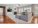 Cozy living room boasts a fireplace, built-in shelving, large windows, and a plush sofa at 4853 Walnut Grove St, Harrisburg, NC 28075