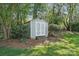A backyard storage shed provides extra space for tools and equipment, set in a landscaped yard with mature trees at 4853 Walnut Grove St, Harrisburg, NC 28075