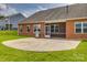 Spacious backyard with a concrete patio and brick home exterior, perfect for outdoor activities at 4926 Trayton Ave, Gastonia, NC 28056