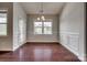 Dining room with wood floors, paneled walls, and natural light from the window and door at 4926 Trayton Ave, Gastonia, NC 28056