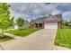 Inviting exterior shot of a brick home with a manicured lawn and ample driveway space in a quiet neighborhood at 4926 Trayton Ave, Gastonia, NC 28056