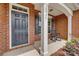 Close-up view of the front entrance with a black door and cozy porch seating at 4926 Trayton Ave, Gastonia, NC 28056