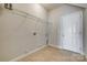Laundry room with a utility sink, shelving, and ample space for laundry appliances and storage at 4926 Trayton Ave, Gastonia, NC 28056