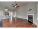 Living room showcasing the hardwood floors, staircase, and fireplace with a modern aesthetic at 4926 Trayton Ave, Gastonia, NC 28056