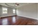 Spacious main bedroom with wood floors, tray ceiling, ceiling fan, and large windows at 4926 Trayton Ave, Gastonia, NC 28056