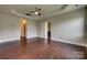 Main bedroom with wood floors, tray ceiling, ceiling fan, and ensuite bathroom at 4926 Trayton Ave, Gastonia, NC 28056
