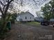A large backyard featuring gravel ground covering with parked car at 522 Pennsylvania Ave, Charlotte, NC 28216