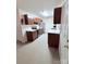 Kitchen featuring wood cabinetry, a stainless steel refrigerator, black range, and marble countertops at 522 Pennsylvania Ave, Charlotte, NC 28216