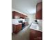 Modern kitchen with stainless steel appliances, marble counters, and wood cabinets at 522 Pennsylvania Ave, Charlotte, NC 28216