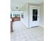 Side porch view, showcasing the white-tiled floor, brick pillars, and a white door leading inside at 522 Pennsylvania Ave, Charlotte, NC 28216