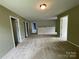 Bright, spacious bonus room featuring multiple entryways and neutral tones at 5619 Fenway Dr, Charlotte, NC 28273