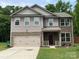 Charming two-story home with stone and siding, featuring a two-car garage and landscaped front yard at 5619 Fenway Dr, Charlotte, NC 28273