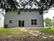 The backyard has a concrete patio, lawn and light green siding on the home at 5619 Fenway Dr, Charlotte, NC 28273