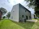 The backyard has a concrete patio, lawn and light green siding on the home at 5619 Fenway Dr, Charlotte, NC 28273