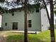 The backyard has a concrete patio, lawn and light green siding on the home at 5619 Fenway Dr, Charlotte, NC 28273