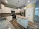 Modern kitchen featuring granite countertops, stainless steel appliances, and an island at 5619 Fenway Dr, Charlotte, NC 28273