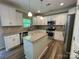 Spacious kitchen featuring stainless steel appliances, granite countertops, and island at 5619 Fenway Dr, Charlotte, NC 28273