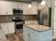Bright kitchen featuring stainless steel appliances, granite counters, and updated cabinetry at 5619 Fenway Dr, Charlotte, NC 28273