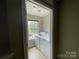 Well-lit laundry room with washer, dryer, window, and shelving at 5619 Fenway Dr, Charlotte, NC 28273