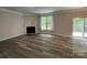 Cozy living room features a fireplace, window, and sliding glass door at 5619 Fenway Dr, Charlotte, NC 28273