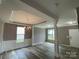 Bright living room showcasing tray ceilings, decorative columns, wainscoting, and wood-look flooring at 5619 Fenway Dr, Charlotte, NC 28273