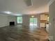 Spacious open-concept living room featuring a fireplace, access to the kitchen, and natural light at 5619 Fenway Dr, Charlotte, NC 28273