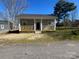 Charming single-story home featuring a cozy front porch and manicured lawn at 567 5Th St, Chester, SC 29706