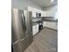 Contemporary kitchen with a stainless steel refrigerator and white cabinets, maximizing space at 567 5Th St, Chester, SC 29706