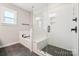Bright bathroom featuring a glass-enclosed shower, soaking tub, and natural light at 5712 Runnel Way, Charlotte, NC 28215