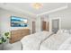 Bright bedroom featuring a flat screen TV, plush bed, and a decorative light fixture at 5712 Runnel Way, Charlotte, NC 28215