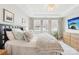 Comfortable bedroom featuring a plush bed, bright windows, and a decorative light fixture at 5712 Runnel Way, Charlotte, NC 28215