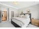 Comfortable bedroom featuring a plush bed, bright windows, and a decorative light fixture at 5712 Runnel Way, Charlotte, NC 28215