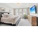Comfortable bedroom featuring a plush bed, bright windows, and a ceiling fan at 5712 Runnel Way, Charlotte, NC 28215