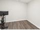 Empty room with a stationary bicycle and dark floors at 5712 Runnel Way, Charlotte, NC 28215