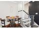 Cozy dining area near stairs featuring hardwood floors and modern fixtures at 5712 Runnel Way, Charlotte, NC 28215