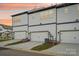 Townhouse garage exterior view with modern design and warm sunset backdrop at 5712 Runnel Way, Charlotte, NC 28215